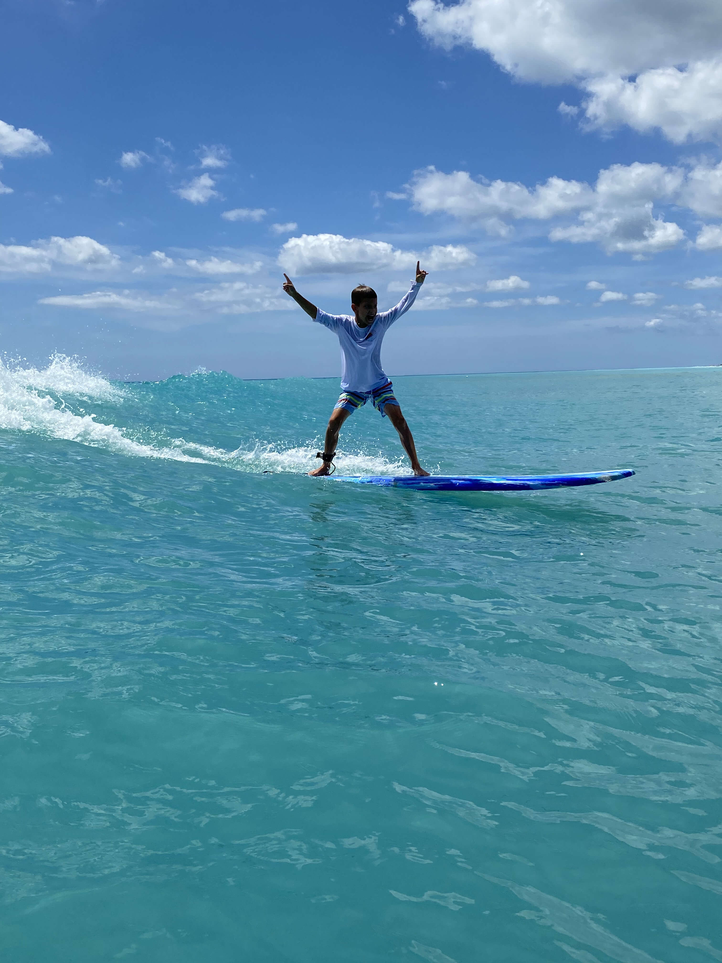 Two surfers celebrating a shared wave