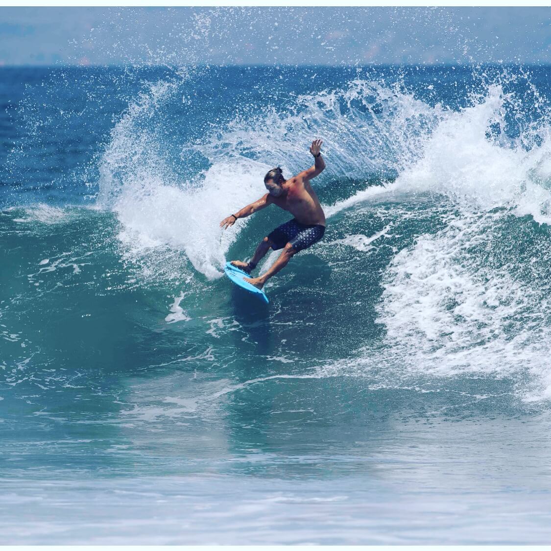 Pete surfing a wave with power and style